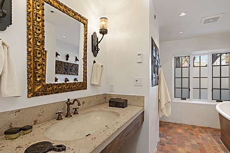 Fabulous hand hewn custom stone lavatory and great mirror