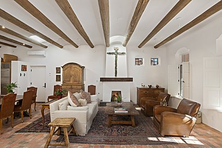 Living Living room with fireplace high coved ceilings brick floors lots of light