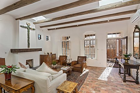 Handsome Living room with high coved ceilings brick floors skylight