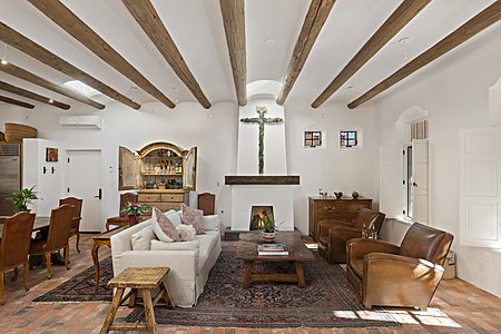 Handsome Living room with high coved ceilings brick floors lots of light