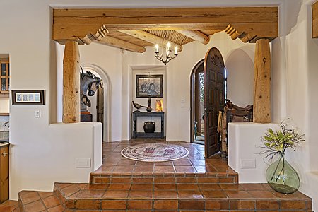 Custom Details in the Entry include a Large Carved Arched Door