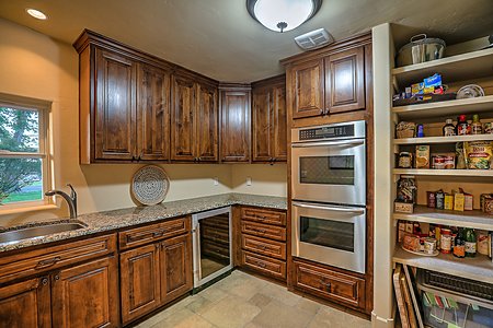 Butlers pantry includes thermador double ovens, wine fridge, sink and extensive storage 