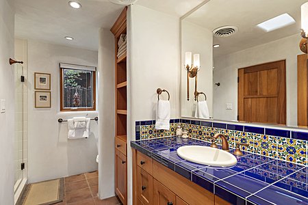 Guest bath with colorful ceramic tiled vanity
