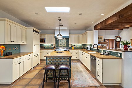 Chef's kitchen with granite countertops and Tunisian tile accents