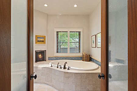 Jetted soaking tub with inset wood burning fireplace 