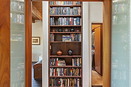 Doors leading to Master Suite featuring custom built bookshelf