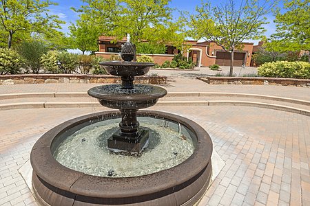 Central fountain in paved neighborhood plaza
