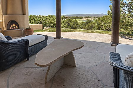 Primary portal with kiva fireplace and golf course views