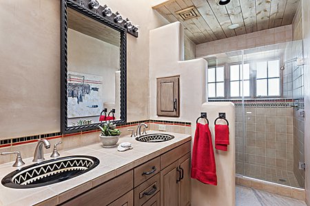 Second guest suite bath with dual vanities and a walk in shower
