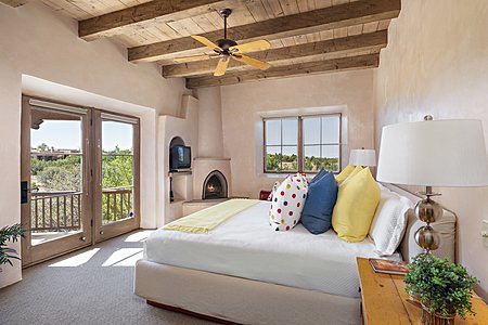 First guest suite with kiva fireplace and access to private patio
