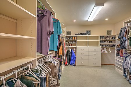 Owners suite includes two separate walk in california system closets 