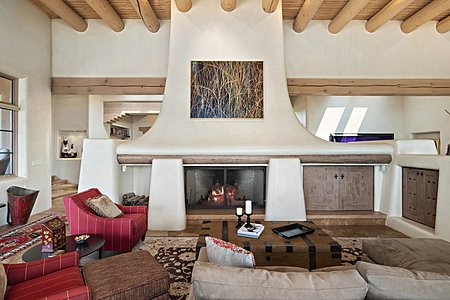 The living room features a wrap around shepherd style fireplace