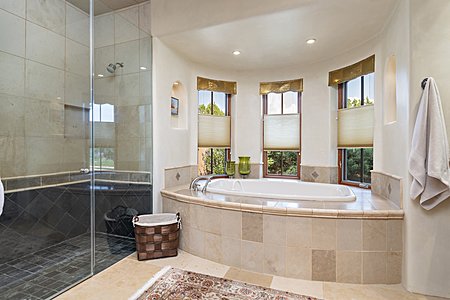Elegant walk in shower and tub in the Primary Suite