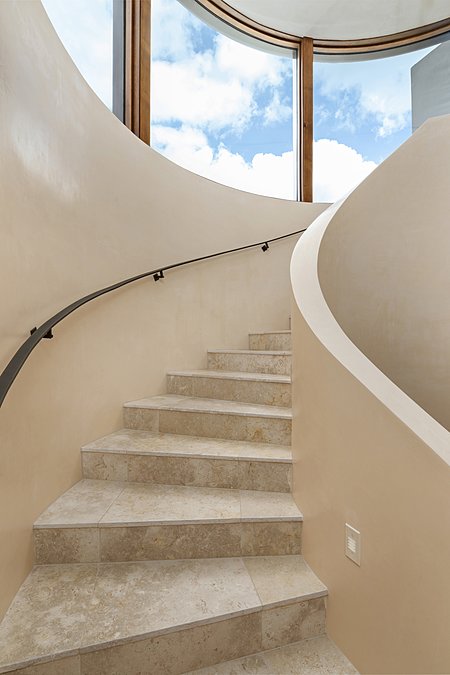 Gorgeous Stairway with Curved Glass Windows