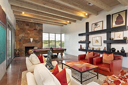 Spacious Living Room has a Dramatic Rock Fireplace as well as Golf & Mountain Views