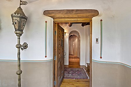 Historic entry invites you in through handpainted wall detail and a Moroccan torchere with lintels over doors and windows,