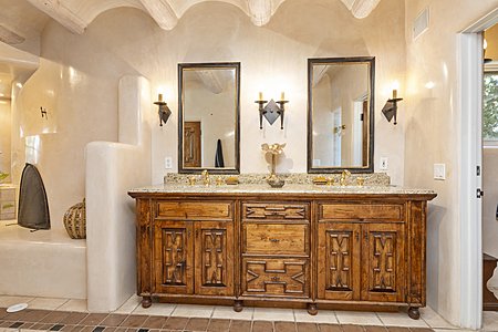 Indulge in exotic handcarved cabinetry, coved ceilings, and luscious diamond plaster in the main master bathroom 