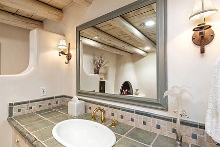Handsome tiles, fixtures, and finishes, a fireplace and privacy!