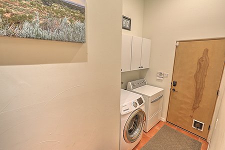 Separate laundry room service room with storage 