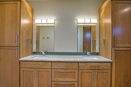Owners suite with double sink, and abundant custom cabinets