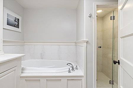 Tub and walk in shower in primary ensuite bathroom