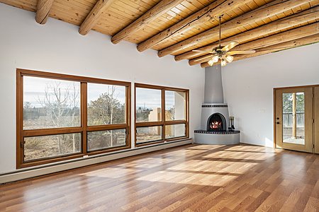 Bright living room with wood burning Kiva fireplace