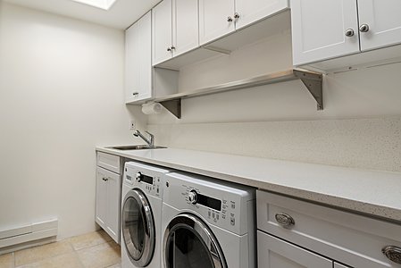 Laundry room with sink and skylight
