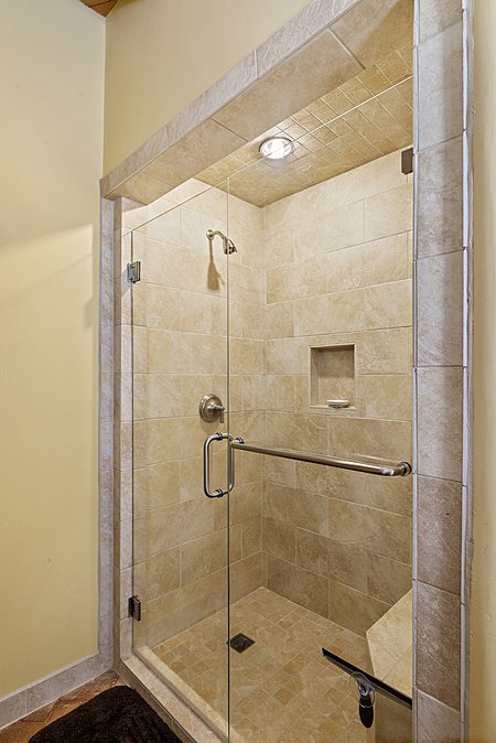 Guest Suite 2 contains a large walk in shower with inset lighting 