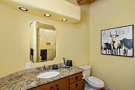 Guest Suite 1 has an en suite bathroom with marble vanity and walk in shower