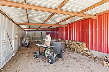 Covered storage and work area off the Barn