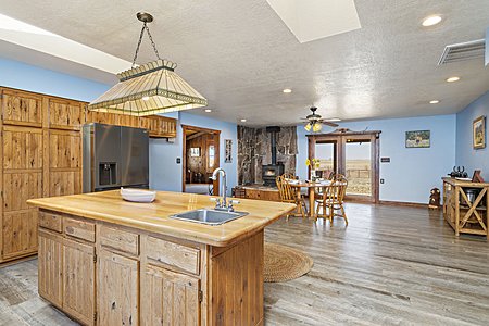 View of open Kitchen and Dining room with wood burning stove