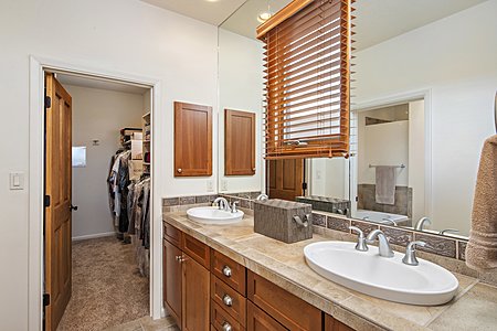 Double sinks in owners suite with large walk in closet