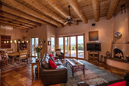 Views from formal Dining room and Living room onto grand Portal with spectacular views of Jemez and landscaped garden