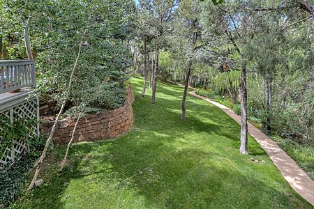 Summer 2019 photo of landscaped yard & concrete path from Main House to Guest House