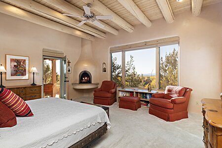 Master bedroom with fireplace and East mountain views