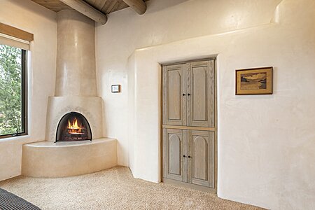 John La Master signature Kiva fireplace in primary bedroom