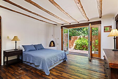 Bedroom # 2 has distressed planked pine floor & French doors to a walled terrace
