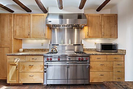 Four burner + grill + griddle Wolf range with two ovens & Viking hood