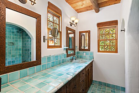 Owner's Bathroom tiled vanity with hand adzed framed mirrors