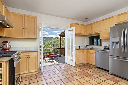 Kitchen opening up to al fresco dining on the deck (Kitchen features Stainless appliances)