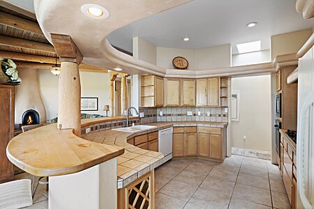 Curved Kitchen with Ample Storage and Countertop Area