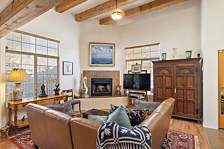 Living room with Kiva fireplace and beam ceiling.