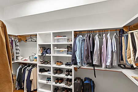 Large walk in primary closet with built in organizers.