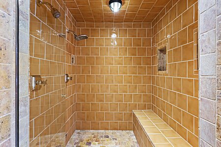 Spacious gold shower with full length bench