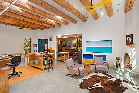 A mellow studio, a woodburning kiva fireplace, and high viga ceilings