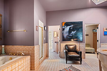 Spacious master bath includes big tub, separate shower, private loo behind door, double vanities, and huge walk--in closets!
