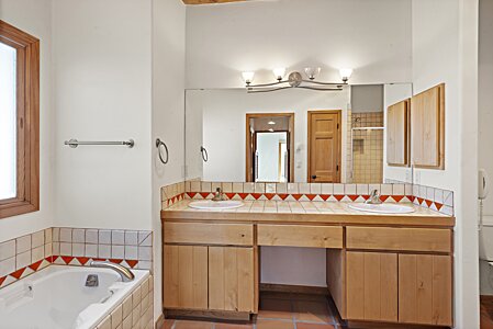 Double vanities and a soaking tub in the primary suite.