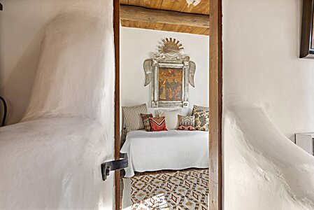 Wonderful, handtrowelled adobe walls lead into the second room of the guest suite.