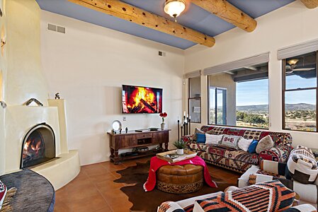 Living area w/  woodburning Fireplace, looking to the View