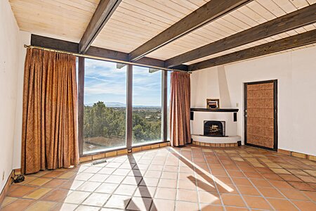 Primary bedroom with beautiful views and a Kiva fireplace